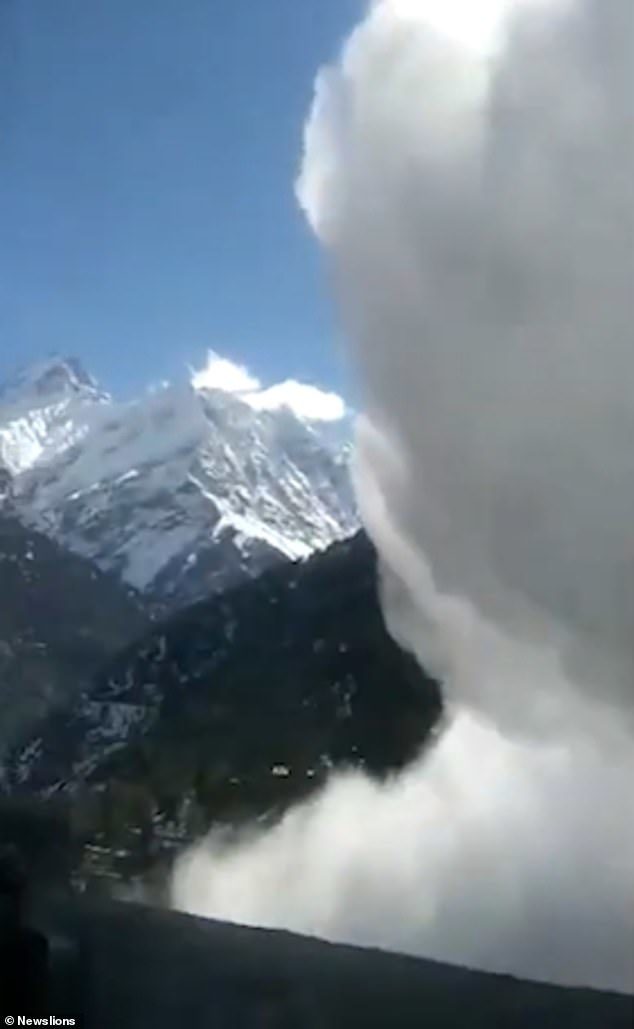 Mountain scenes covered by a massive cloud of powdery snow as the avalanche takes hold