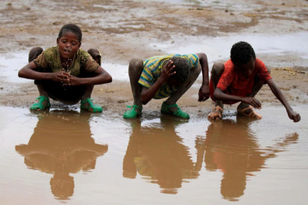 Varios niños se mojan la cara en un río en Kobo (Etiopía)
