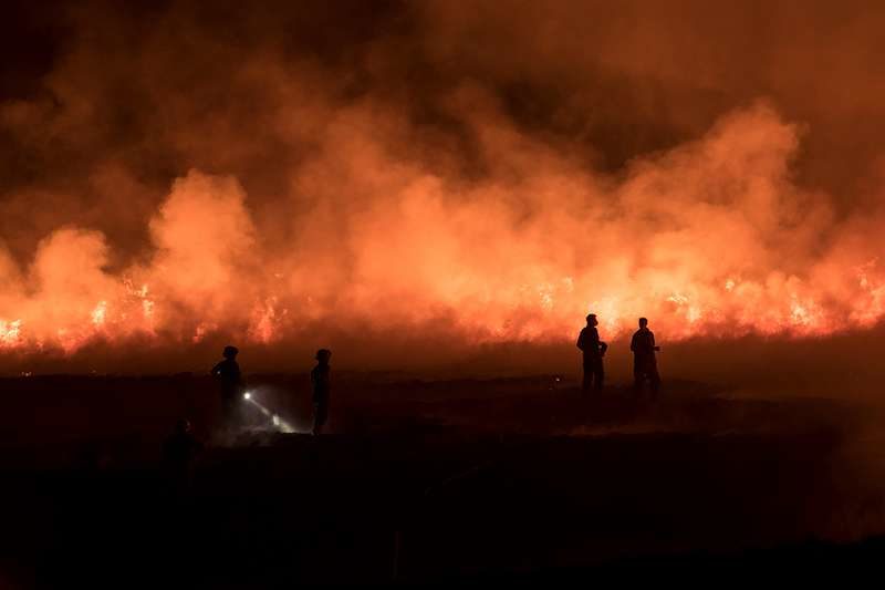 Firefighters tackle a blaze on moorland in northwest England