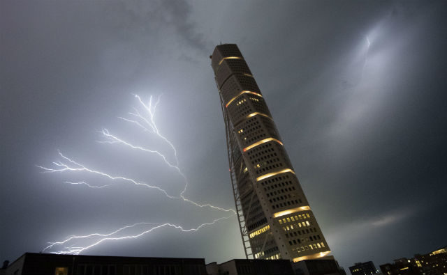 Lightning strikes behind Malmö's Turning Torso tower.