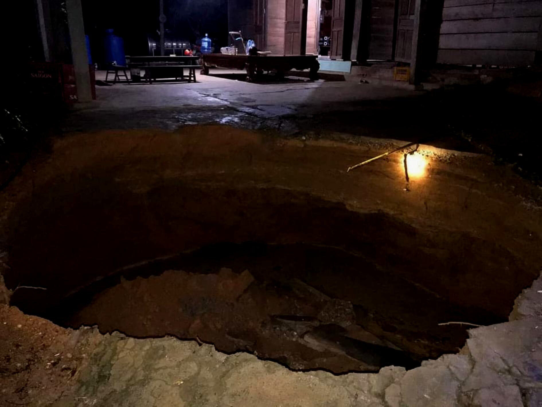 A large sinkhole emerges in the front yard of a house in Quang Binh Province, Vietnam, September 28, 2020.