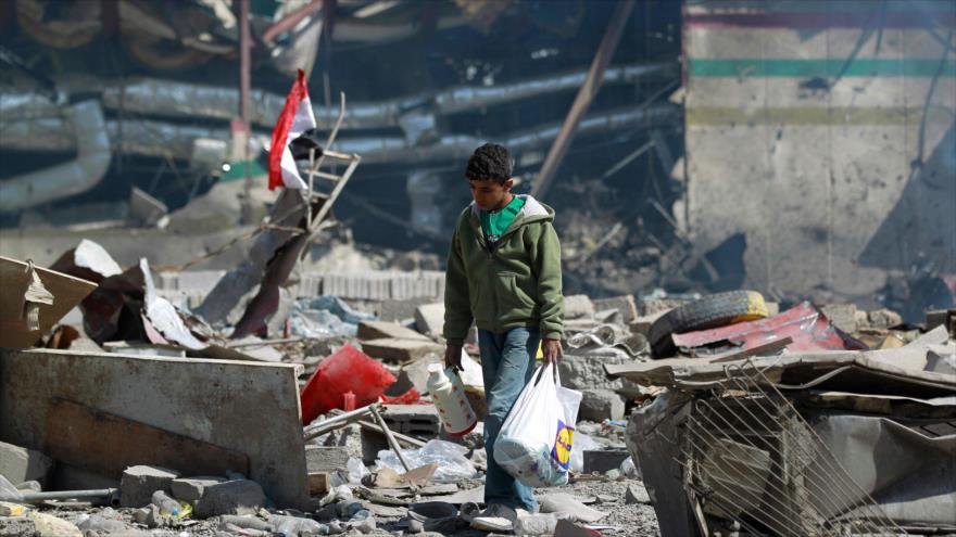 Niño yemení camina entre los escombros de una escuela bombardeada por Arabia Saudí en Saná (capital).