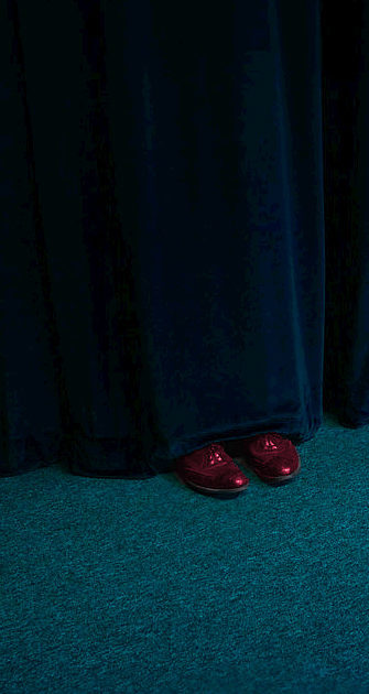 The shoes behind the curtain