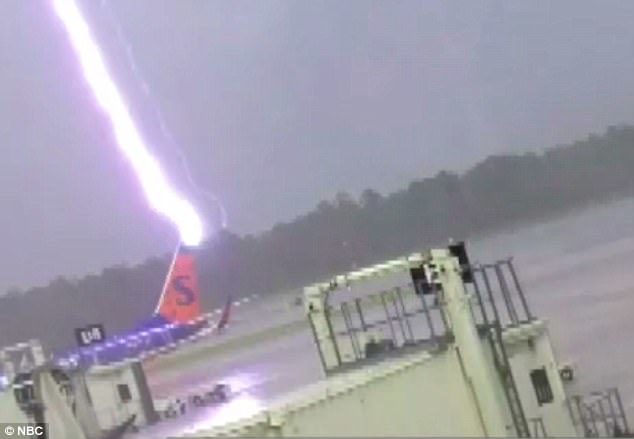 Surveillance video form the airport shows the bolt of lightning first striking the tail of a Sun Country plane at Southwest Florida International Airport on July 22