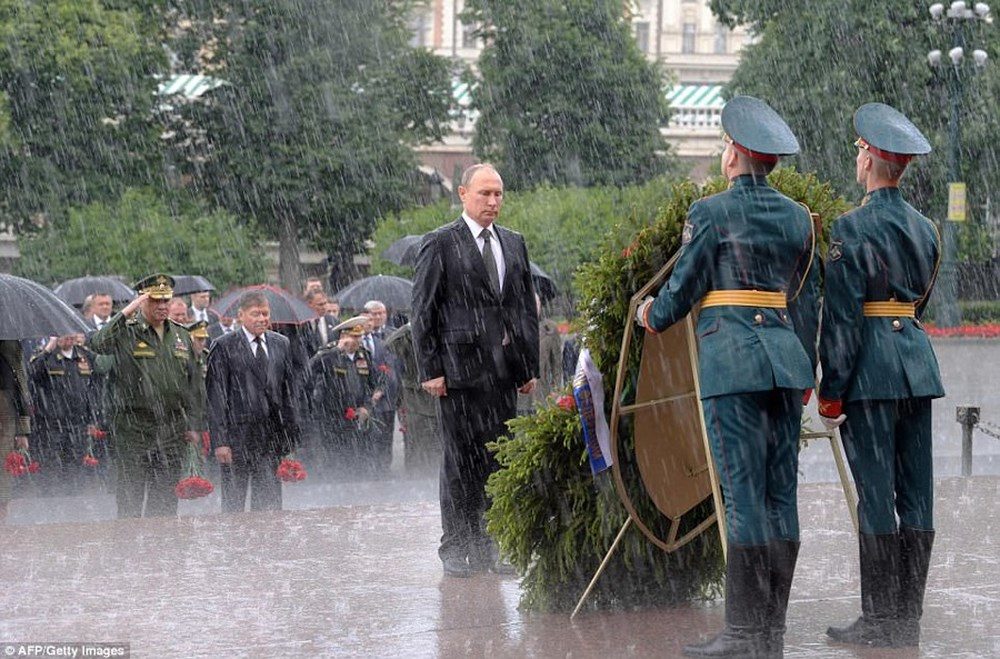 Putin standing in rain