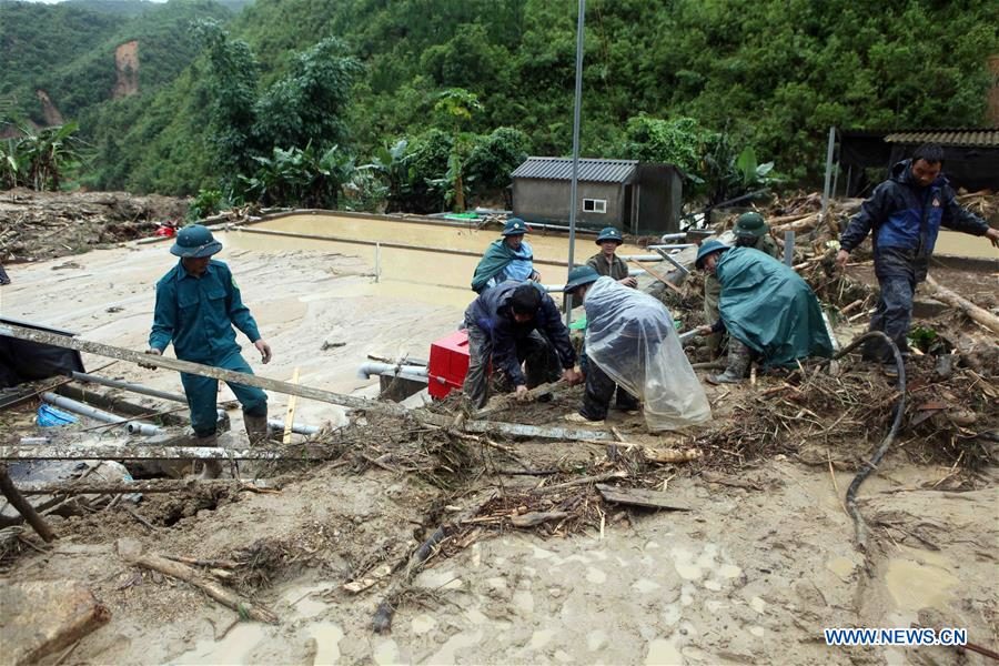 Rescuers work at the flood-affected area in Lai Chau province, north of Vietnam, on June 25, 2018.