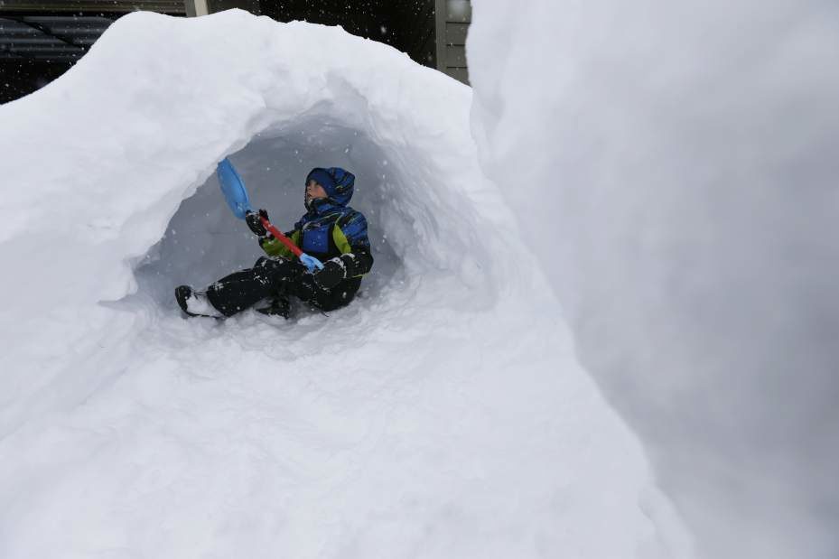 Seven-year-old Cole Ruff works on digging a snow fort in a large pile of snow after his father shoveled their driveway Monday, Feb. 25, 2019. (Ryan Brennecke/Bulletin photo)