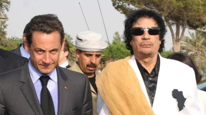 Nicolas Sarkozy (L) with Gaddafi