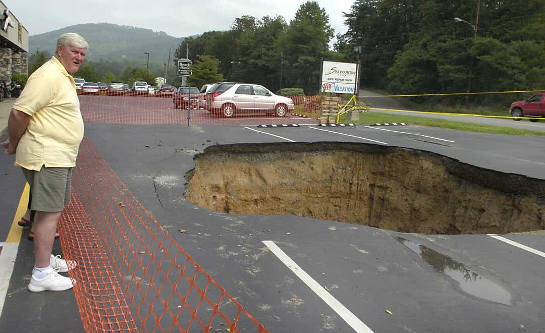 A sinkhole opened up in the parking lot of the Asheville AAA office on Merrimon Avenue