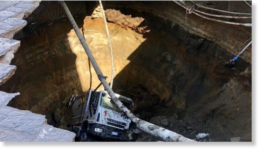 A garbage truck plunged into a massive sinkhole in the Italian city of Naples. (Vigili del