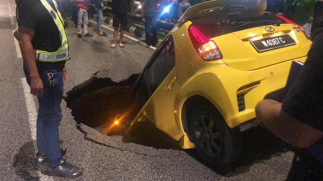 A Myvi was swallowed by a sinkhole in the heart of Kuala Lumpur on Nov 25