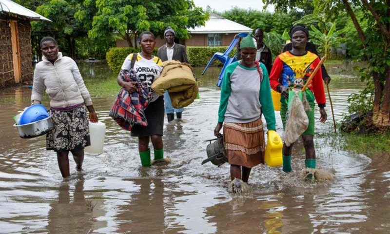 Displaced families flee to higher ground in K'akola village in Nyando sub-county in Kisumu, Kenya, after their houses were flooded on December 3, 2019