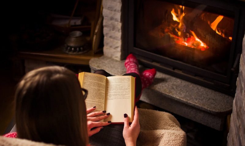 reading by fireplace