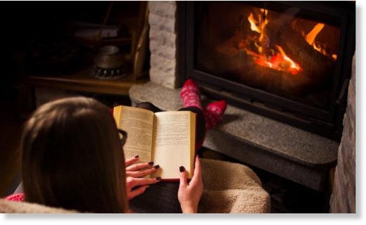 reading by fireplace
