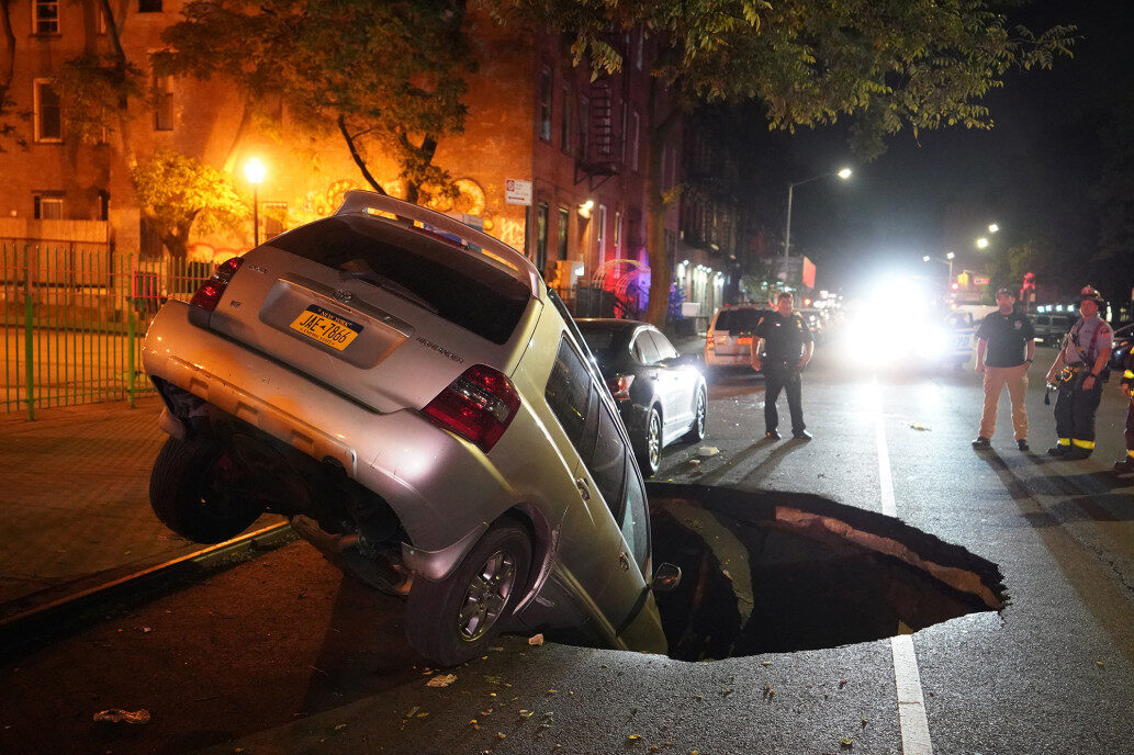 A parked car fell into a sinkhole on 2nd Street.