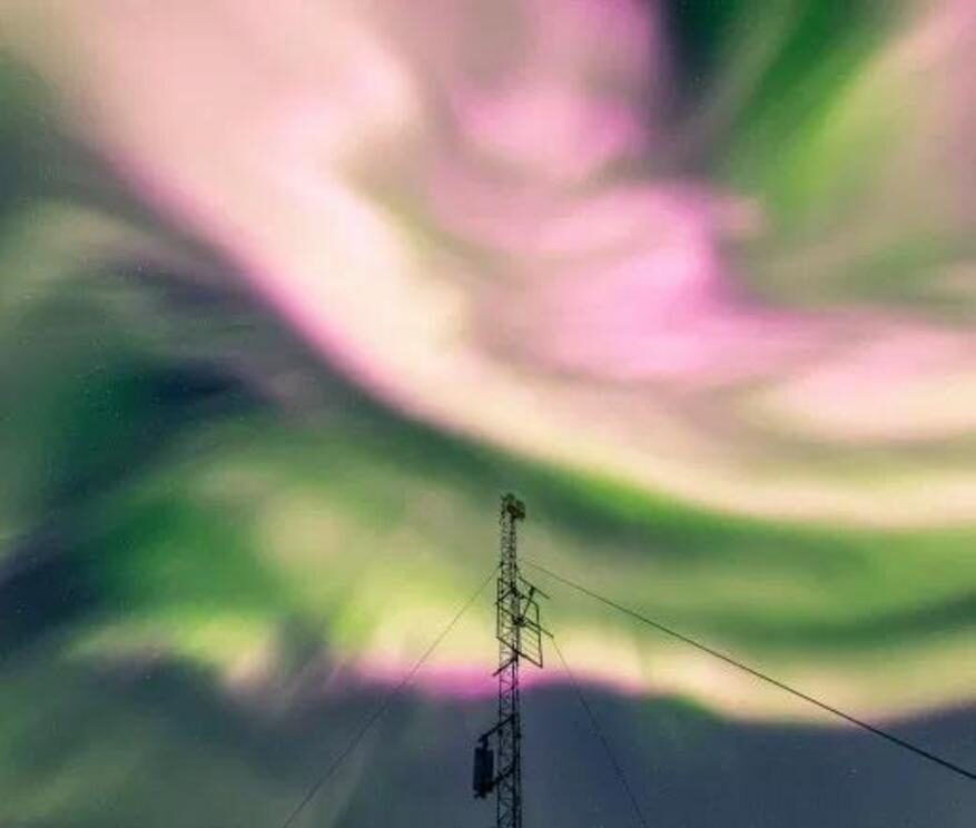 The northern lights appear pink over Tromso, Norway, on Saturday night.