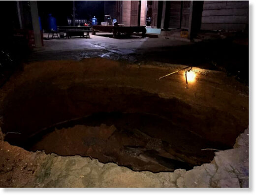 A large sinkhole emerges in the front yard of a house in Quang Binh Province, Vietnam, September 28, 2020.