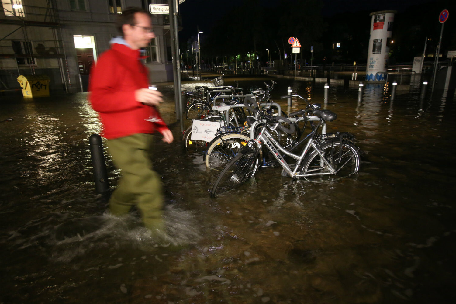 A man wading through the flooding in Lübeck.