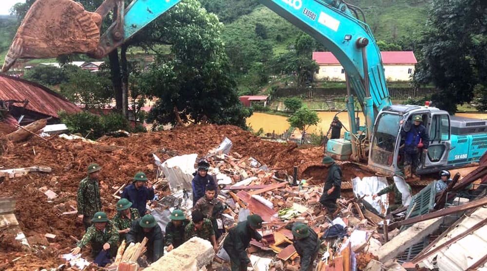 This picture taken on October 18, 2020 and released by the Vietnam News Agency on October 18, 2020 shows military personnel searching for missing soldiers at the site of a landslide in central Vietnam's Quang Tri province.