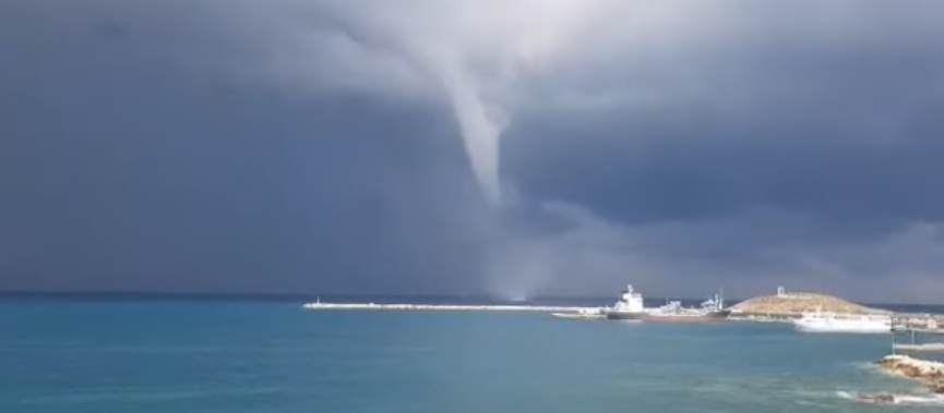 A waterspout, or sea tornado, forming above the Greek island of Naxos.