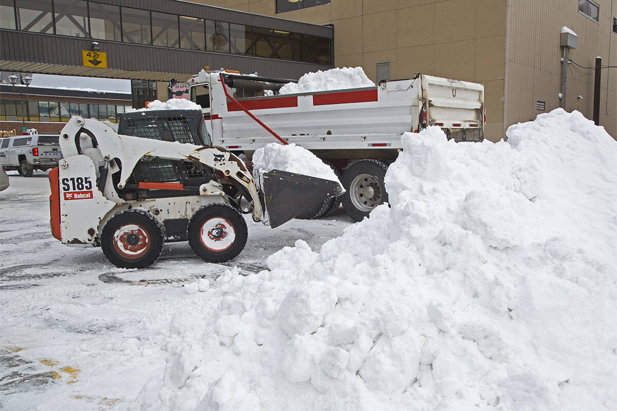 A bobcat is used to help clear snow in downtown