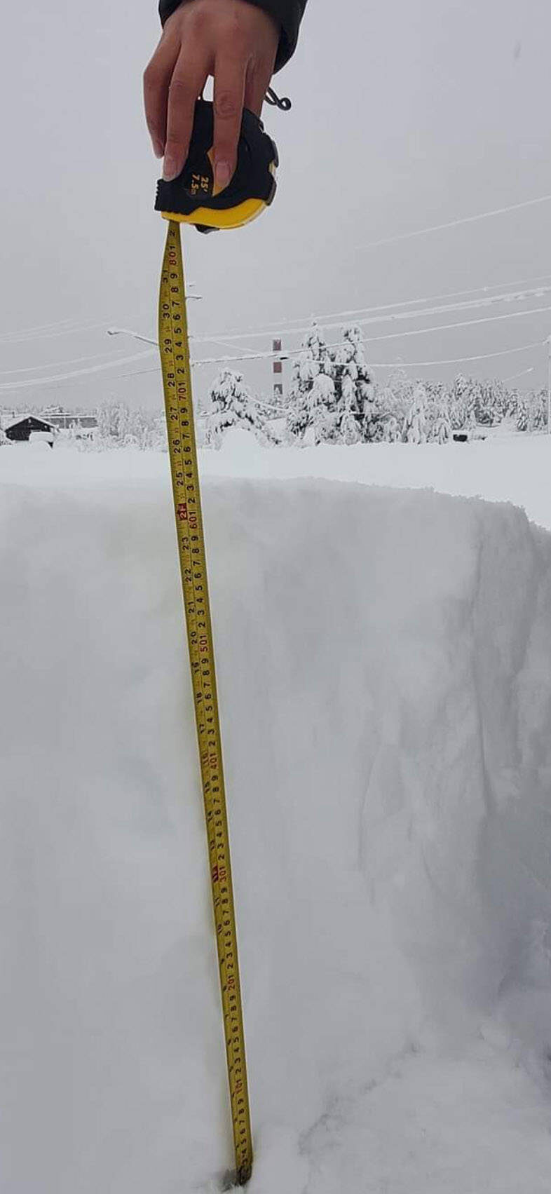 A member of Ulkatcho First Nation measures the snow on Friday, Nov. 27, 2020 showing that more than 60 cms of snow has fallen since a snowfall warning went into effect for northern portions of the Chilcotin on Thursday