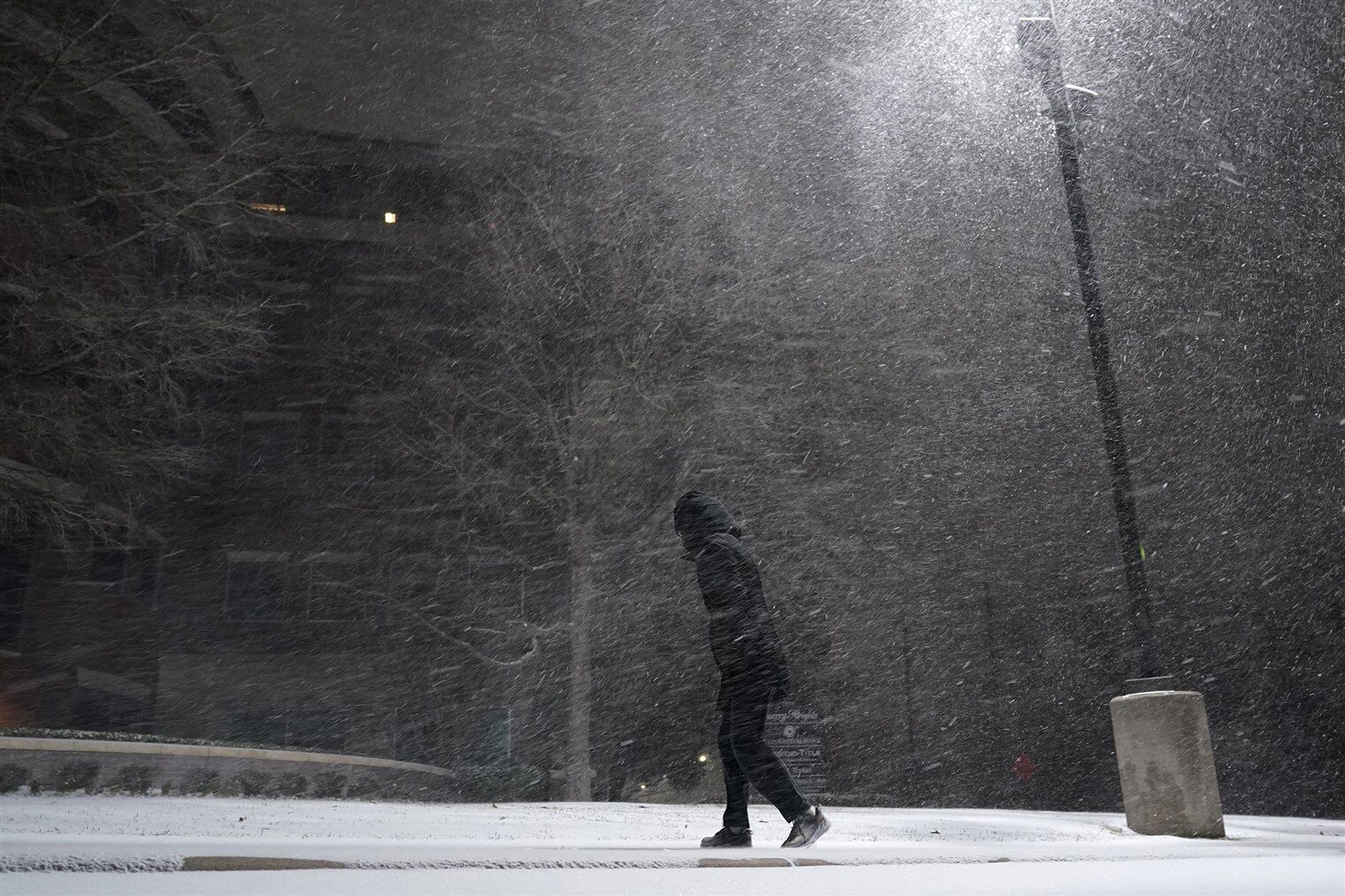 A woman walks through falling snow in San Antonio, Texas on Sunday.