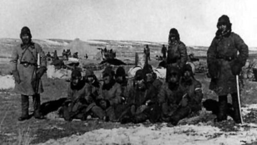 Soldados japoneses custodiando prisioneros chinos durante el periodo invernal en Manchuria para un experimento de congelación.