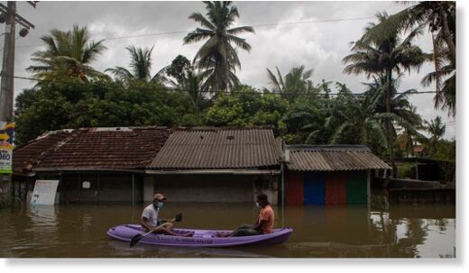 A raft floats along a flooded street in Malwana, Sri Lanka on Saturday.