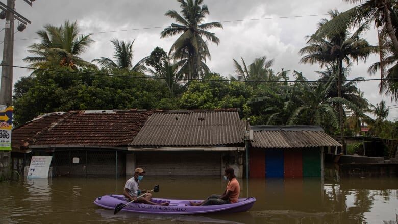A raft floats along a flooded street in Malwana, Sri Lanka on Saturday.