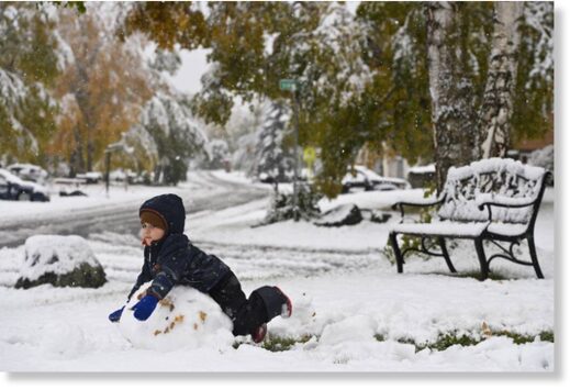 Two-year-old Ramiar Harki plays in the snow in his East Anchorage yard on September 24, 2021.