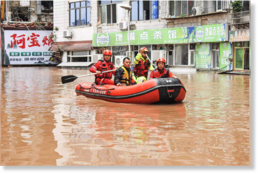 Rescuers evacuating residents in a flooded area after heavy
