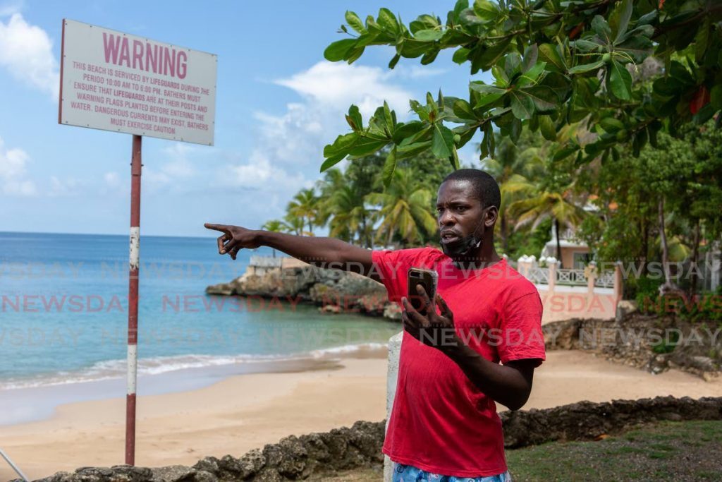 Fisherman Romell Rivers points to where a waterspout developed over Store Bay on Monday morning.