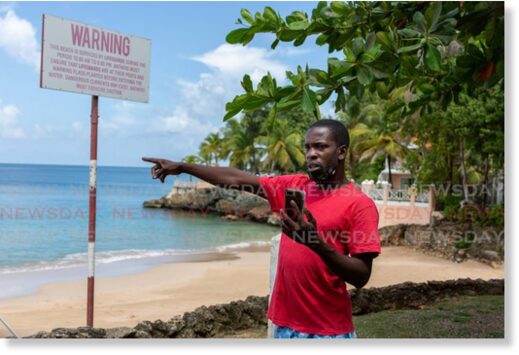Fisherman Romell Rivers points to where a waterspout developed over Store Bay on Monday morning.