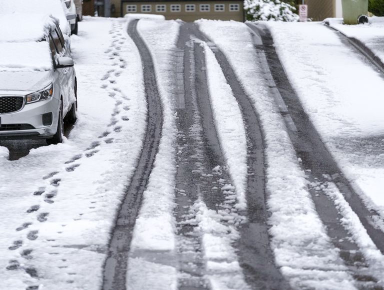 A few tire tracks and footprints lead down a hill in the Bethany area, April 11, 2022,nieve,Portland