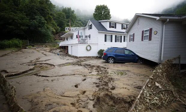 A house in Whitewood, Virginia, was pulled from its foundation after a flash flood.