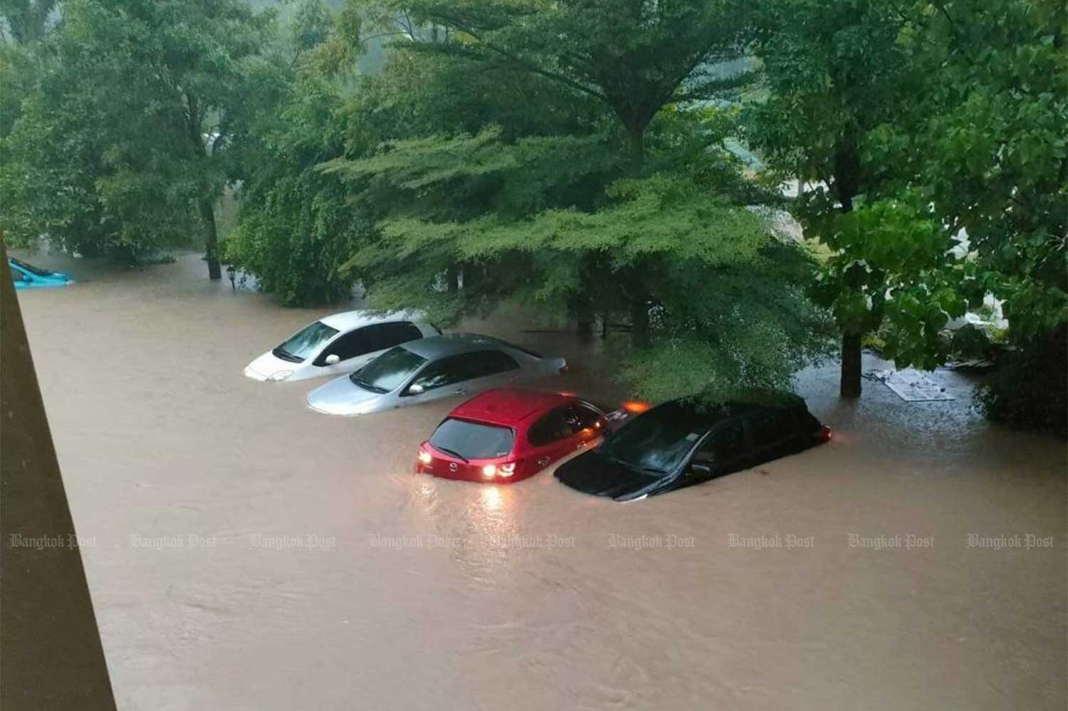 Flood water inundates cars, one