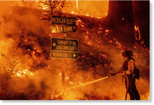 A firefighter battles the Mosquito Fire in Placer County, Calif., on Wednesday.