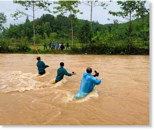 Military force crossing a stream with a rope to move people away from flooded areas to a safe place.