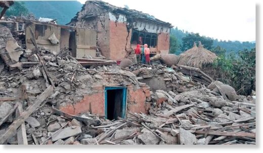 People outside the ruins of collapsed houses in the district of Doti after an earthquake struck Nepal on November 9, 2022.