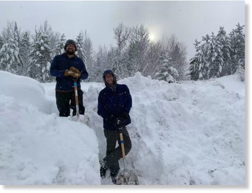 David Stieler (left) and Charlie Pavlisich pose for a photo after shoveling snow at Wolf Ridge Environmental Learning Center in Finland, Minn. on Wednesday.