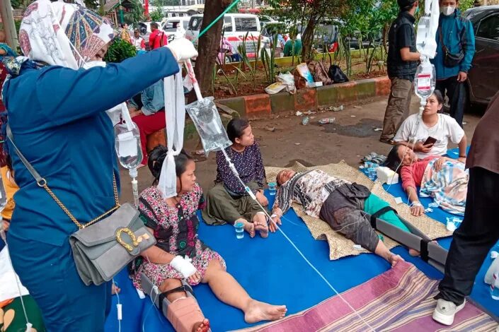 People injured during an earthquake receive medical treatment in a hospital parking lot in Cianjur, West Java, Indonesia (