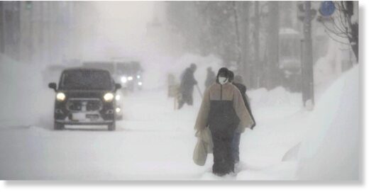 People walk through wind and snow on Monday morning in Shibetsu, Hokkaido.