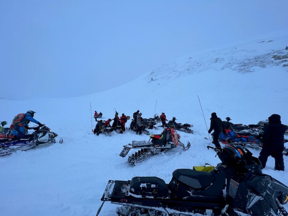 One snowmobiler died and another was missing Saturday after becoming buried in an avalanche in unincorporated Grand County, Colorado, officials said.