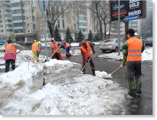 Utility workers in Almaty, Kazakhstan, clearing away snow on the street last week.