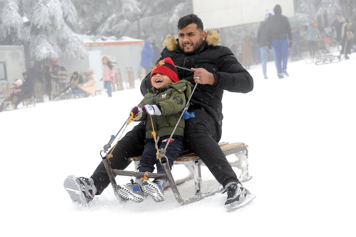 Algerians slide with a sledge at a ski center after snowfall in highlands of Cheria town in Tebessa Province, Algeria on Janaury 23, 2023.