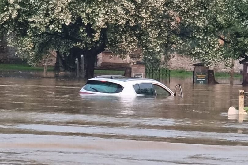 Car submerged in floodwater at the A359 in Queen Camel