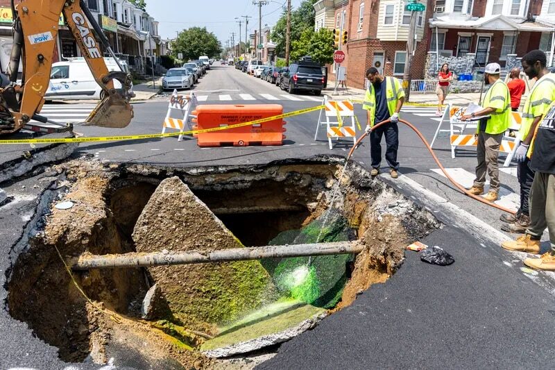 Workers from the Philadelphia Water Department examine the sewage by washing down dyed water to see if there is a hole in the sewage pipe at the cross section of 57th and Media Street in Philadelphia, Pa., on Wednesday, July 26, 2023