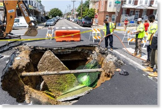 Workers from the Philadelphia Water Department examine the sewage by washing down dyed water to see if there is a hole in the sewage pipe at the cross section of 57th and Media Street in Philadelphia, Pa., on Wednesday, July 26, 2023