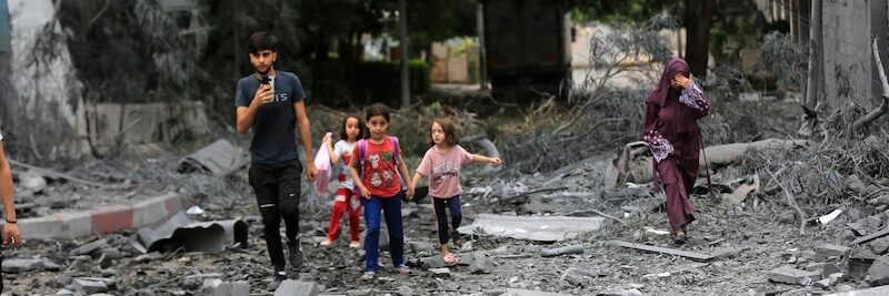 destroyed buildings and debris around the Palestinian Telecommunications Company